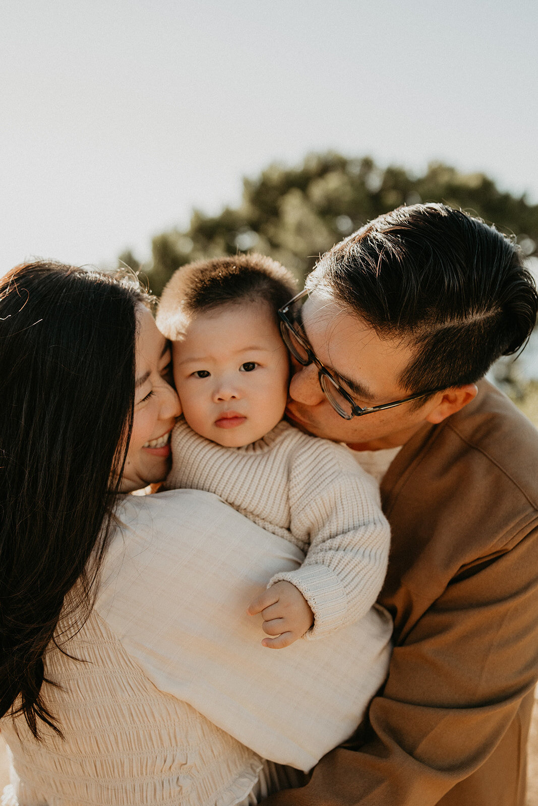 Father kissing his toddler's forehead, tender family portrait