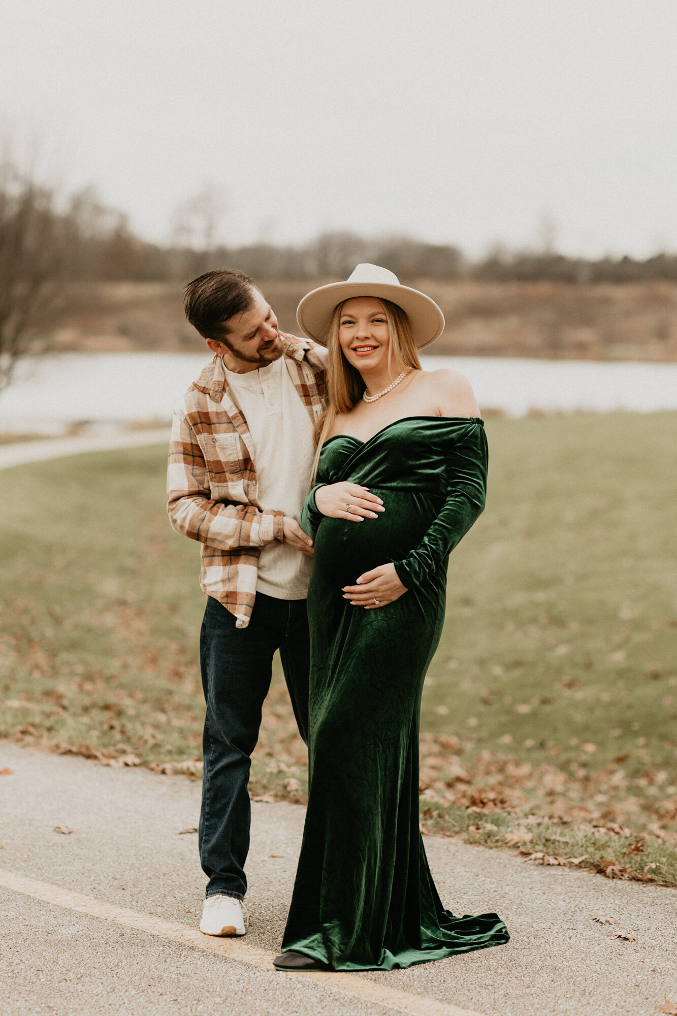 Couple in matching green outfits with their child, editorial family portrait