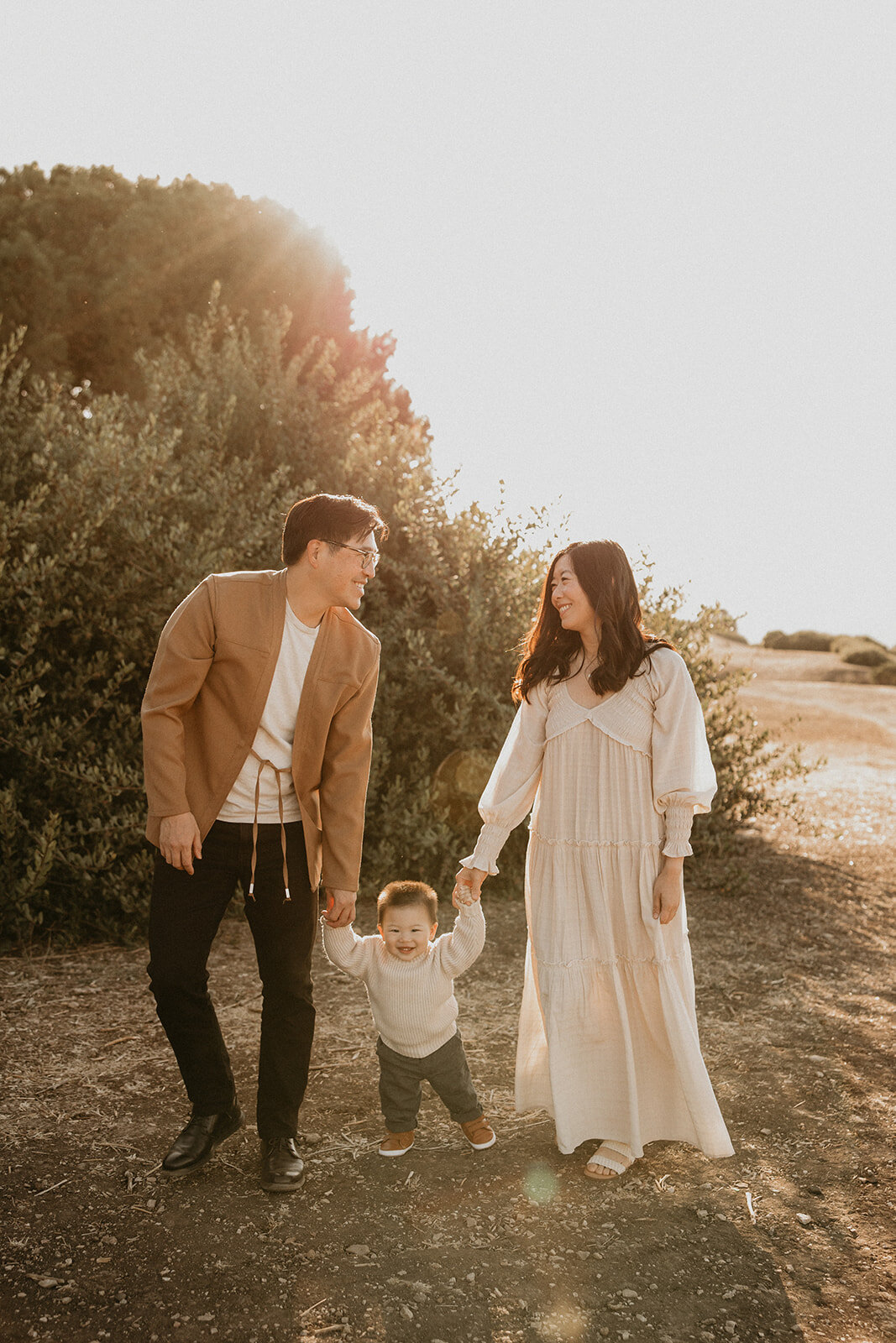 Family walking with their dog on a coastal trail, candid family photography