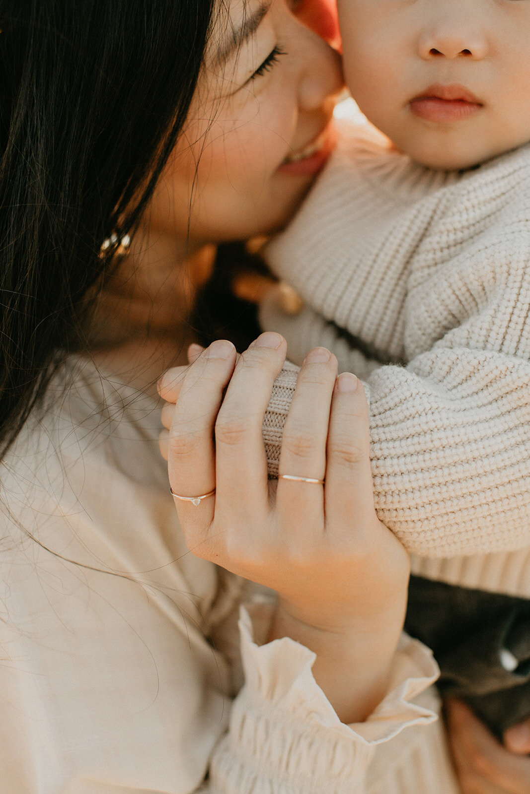 Mother touching noses with her newborn baby in a tender in-home portrait